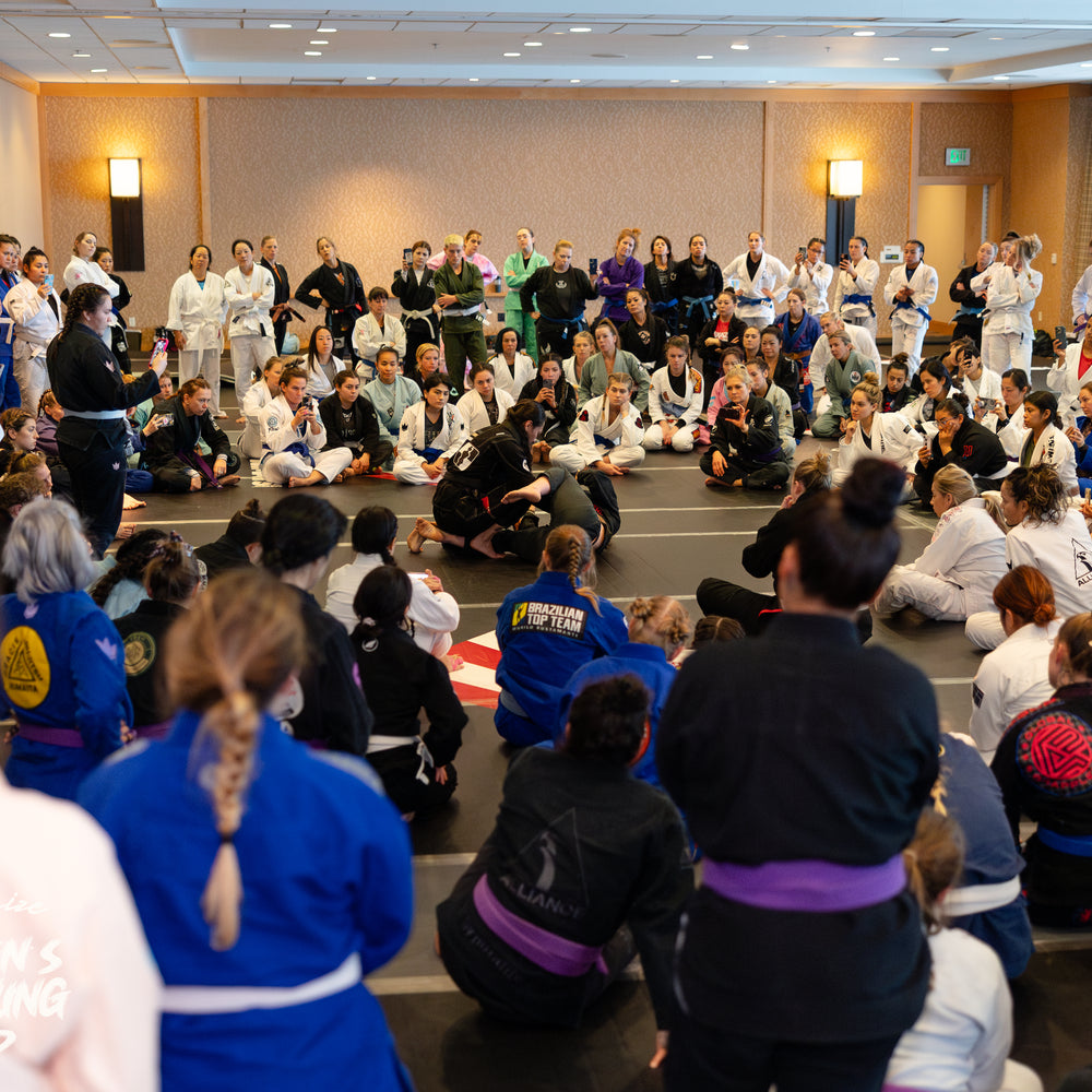 Women in Gis watching a seminar at A Jiu Jitsu event in San Diego