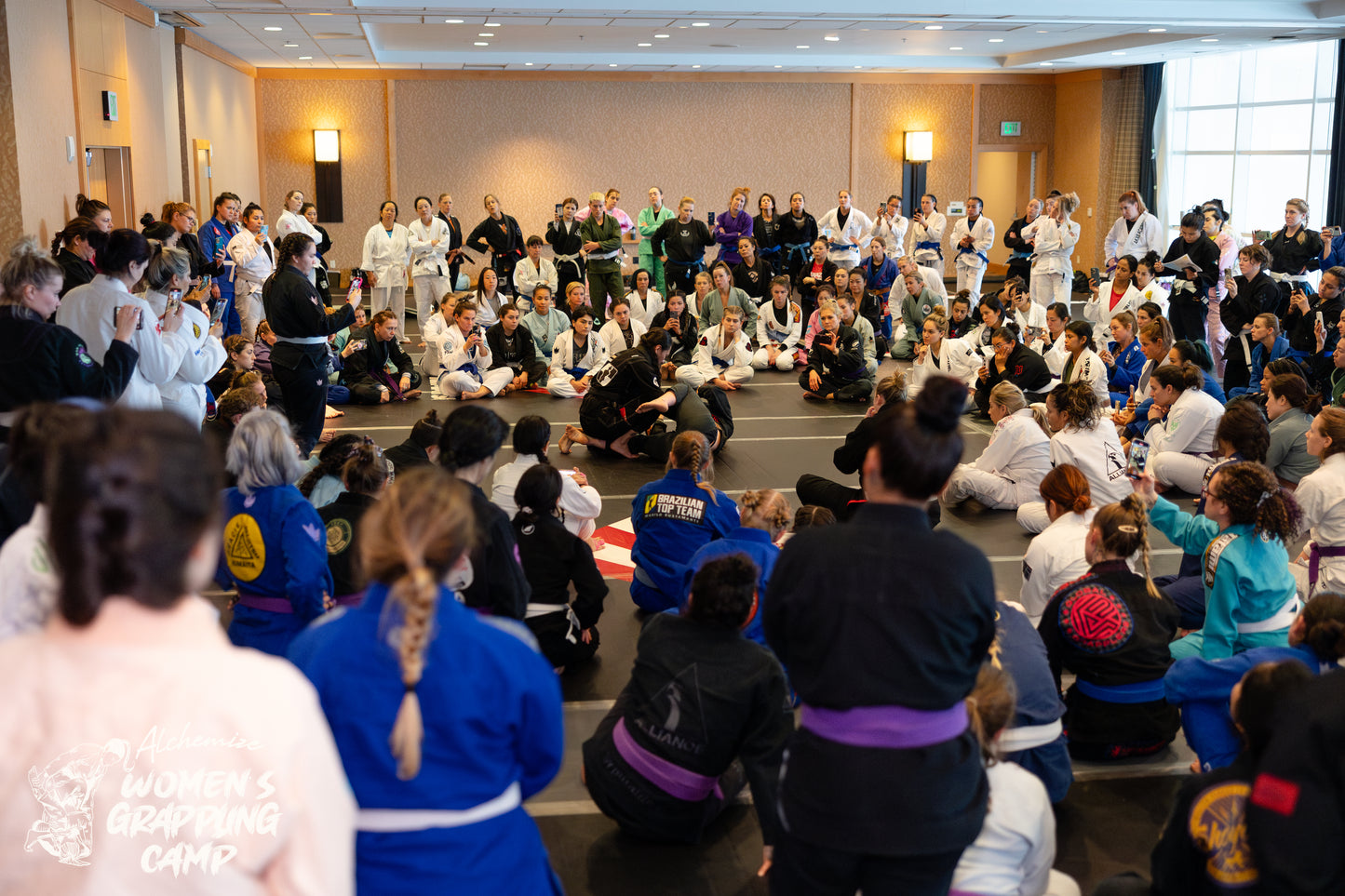 Women in Gis watching a seminar at A Jiu Jitsu event in San Diego