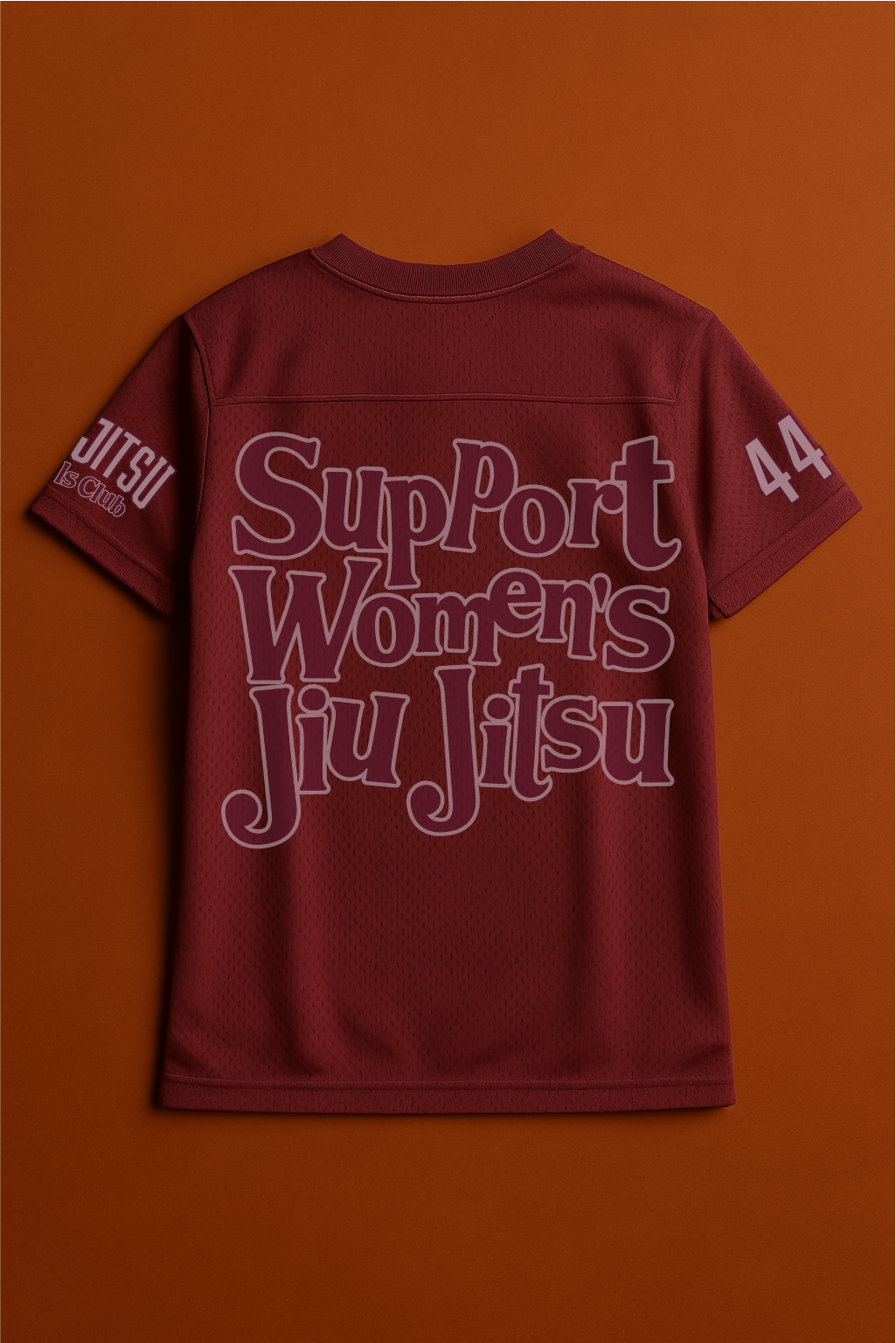 Maroon shirt with 'Support Women's Jiu Jitsu' text on an orange background