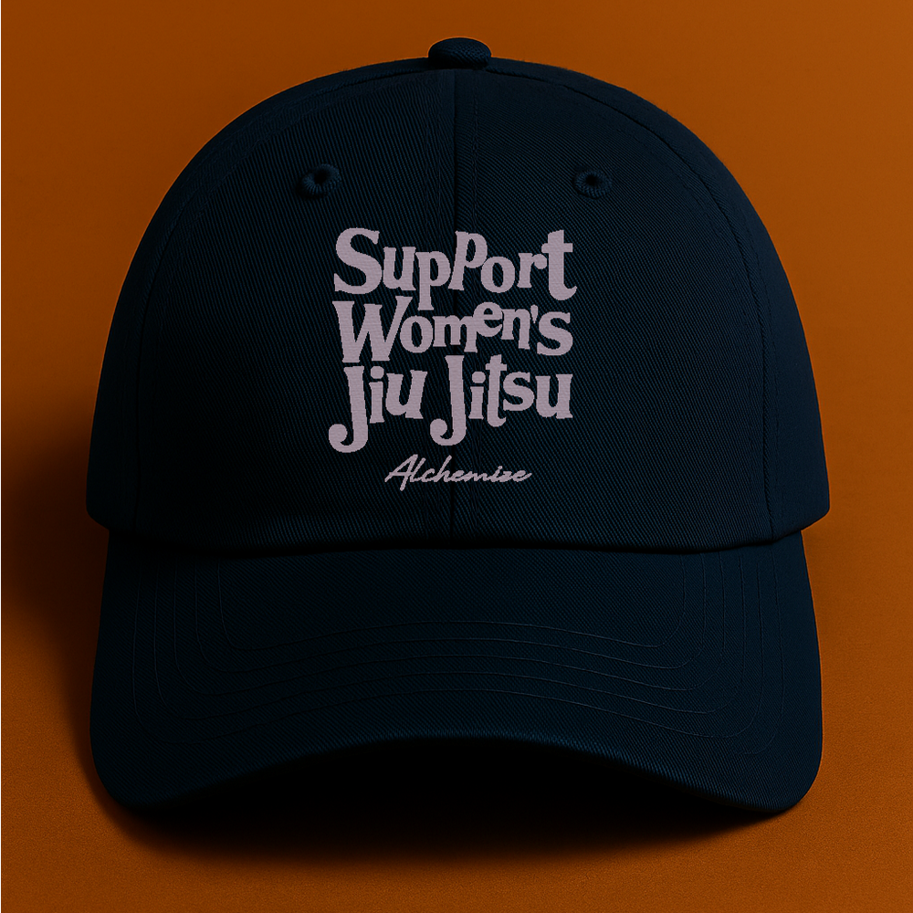 Navy cap with 'Support Women's Jiu Jitsu' text on an orange background