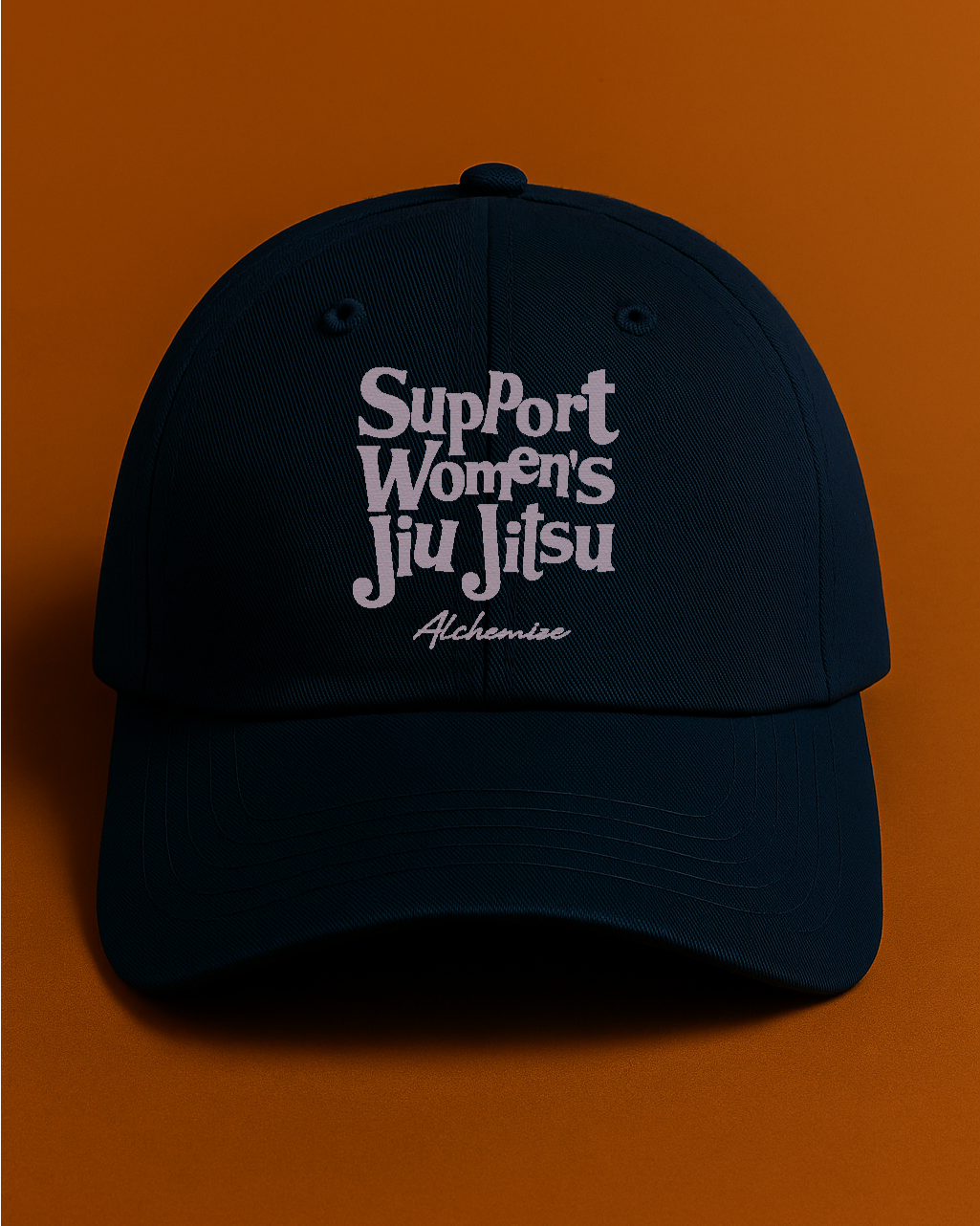 Navy cap with 'Support Women's Jiu Jitsu' text on an orange background