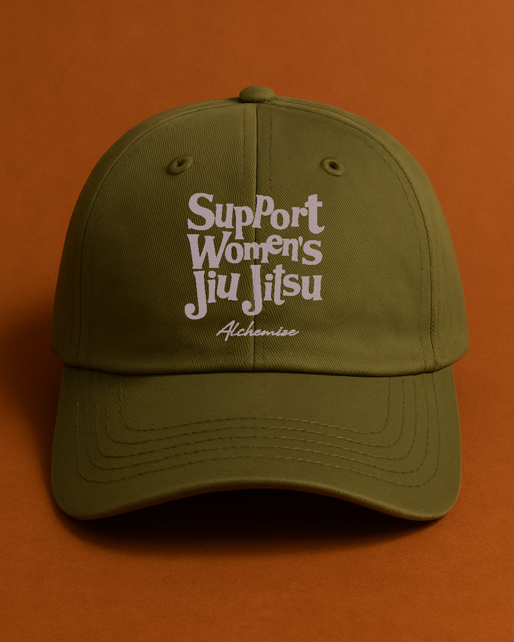 Green cap with 'Support Women's Jiu Jitsu' text on an orange background